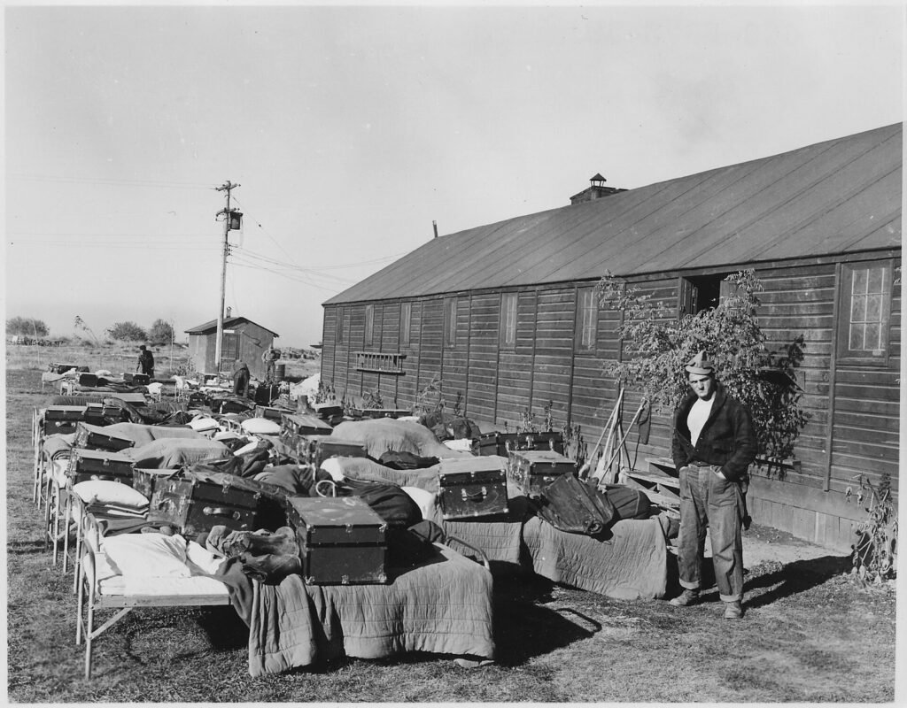 Cots and clothing set out to air on the lawn of a Civilian Conservation Corps camp in Idaho, 1939