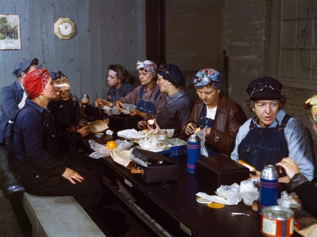 Color photo of women roundhouse wipers eating lunch, Chicago and North Western Railroad, Clinton, Iowa, 1943
