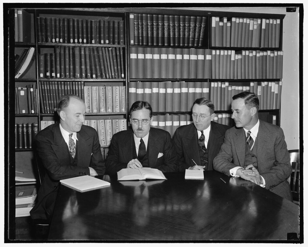Members of the Railroad Retirement Board seated at a meeting table in Washington, 1938