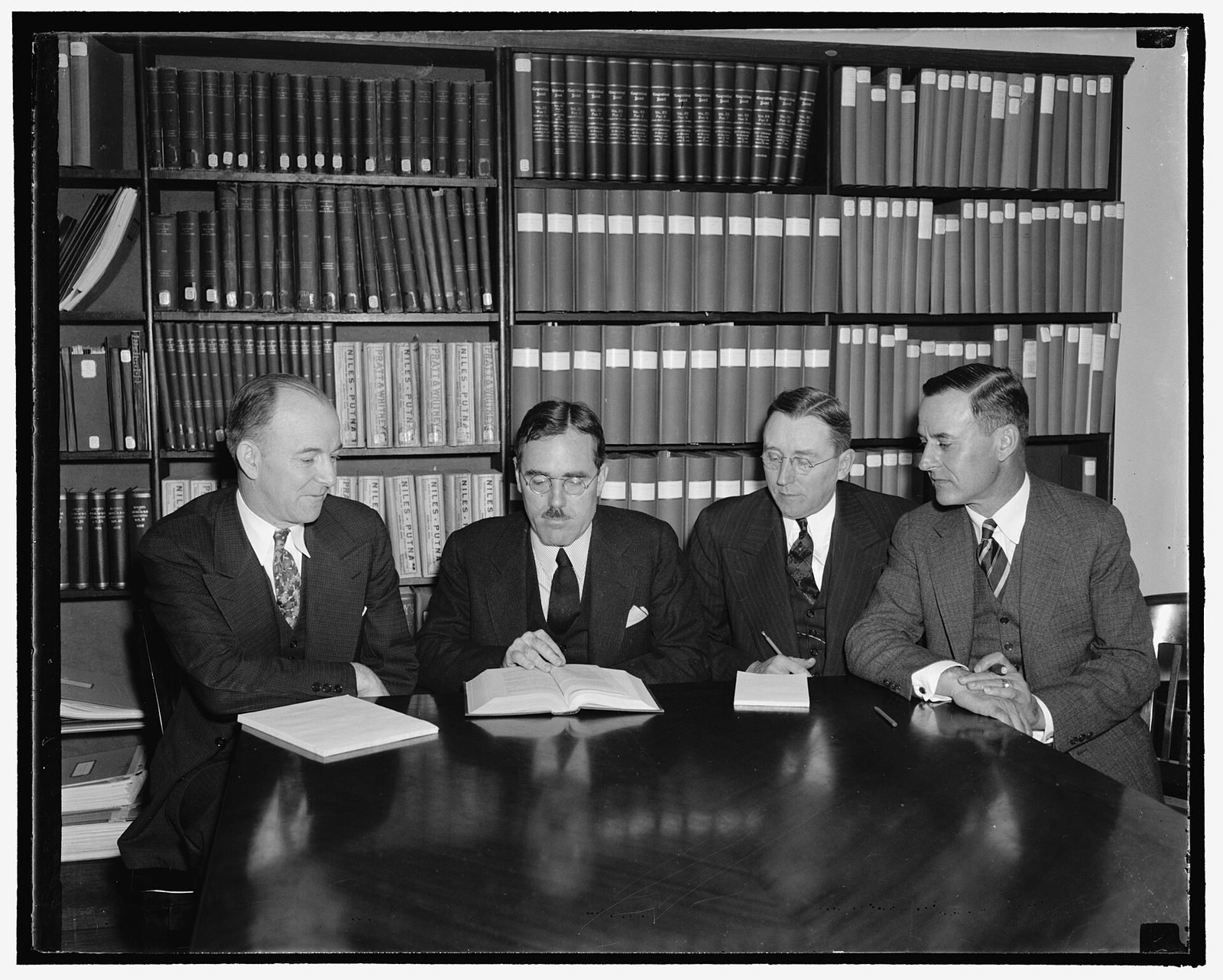 Members of the Railroad Retirement Board seated at a meeting table in Washington, 1938