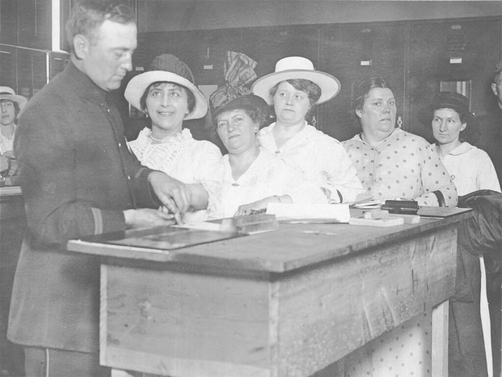 Woman having her fingerprints taken for enemy alien registration, New York City, 1918